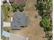 An aerial view of a well-maintained home with a large yard and mature trees at 524 Nogales, Kissimmee, FL 34758