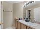 Bathroom featuring double sinks, a large mirror, and neutral wall color at 524 Nogales, Kissimmee, FL 34758