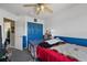 Cozy bedroom with blue accents, wood floors, and ceiling fan at 524 Nogales, Kissimmee, FL 34758