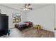 Bright bedroom featuring a ceiling fan, wood-look floors, and natural light at 524 Nogales, Kissimmee, FL 34758