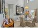 Light-filled dining room boasts tiled floor, large mirror, and glass-topped table at 524 Nogales, Kissimmee, FL 34758
