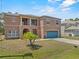 Inviting two-story home with a well-maintained lawn and a two-car garage at 524 Nogales, Kissimmee, FL 34758