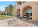 Welcoming front porch with seating area, archways, and beautifully landscaped front yard at 524 Nogales, Kissimmee, FL 34758
