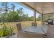 Relaxing outdoor patio with a table and chairs overlooking a large grassy backyard at 524 Nogales, Kissimmee, FL 34758