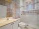 A full bathroom with floral wallpaper and a glass-enclosed shower at 530 Greenway Dr, Lake Wales, FL 33898