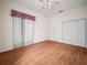 A bedroom with wood floors and a sliding glass door to the exterior at 530 Greenway Dr, Lake Wales, FL 33898