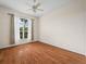 A bedroom with wood floors and a arched window to the exterior at 530 Greenway Dr, Lake Wales, FL 33898