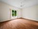 Inviting bedroom with hardwood floors, a ceiling fan, and a large window at 530 Greenway Dr, Lake Wales, FL 33898
