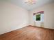 Empty bedroom featuring wood floors and a window with curtains at 530 Greenway Dr, Lake Wales, FL 33898