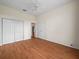 A bedroom with wood floors and a double door closet at 530 Greenway Dr, Lake Wales, FL 33898