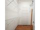 Walk-in closet with shelves, hanging rods, and hardwood floors at 530 Greenway Dr, Lake Wales, FL 33898