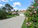Inviting single-story home features a tile roof, a two-car garage, lush landscaping, and a long driveway at 530 Greenway Dr, Lake Wales, FL 33898