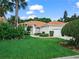 Charming one-story home boasts a tile roof, lush landscaping, well-manicured lawn, and an attached two-car garage at 530 Greenway Dr, Lake Wales, FL 33898