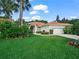 Charming single-story home boasts a tile roof, two car garage, lush landscaping, and a well-manicured lawn at 530 Greenway Dr, Lake Wales, FL 33898