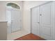 Bright foyer with tiled floor and high ceilings featuring a front door and double closet doors at 530 Greenway Dr, Lake Wales, FL 33898