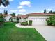 Charming single-story home boasts a well-manicured lawn, lush landscaping, and a welcoming two-car garage at 530 Greenway Dr, Lake Wales, FL 33898
