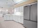 Spacious kitchen boasts stainless steel refrigerator and ample white cabinetry at 530 Greenway Dr, Lake Wales, FL 33898