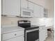 Updated kitchen showcases stainless steel oven, microwave, and white cabinets at 530 Greenway Dr, Lake Wales, FL 33898