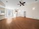Inviting living room featuring hardwood floors, a vaulted ceiling, a ceiling fan, and a large window at 530 Greenway Dr, Lake Wales, FL 33898