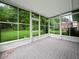 Enclosed sun room with tile floors and views of the backyard at 530 Greenway Dr, Lake Wales, FL 33898