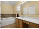Well-lit bathroom with a tub and vanity featuring ample counter space and storage at 533 Ronshelle Ave, Haines City, FL 33844