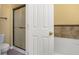 Cozy bathroom space featuring a shower behind a door and a pristine white toilet at 533 Ronshelle Ave, Haines City, FL 33844