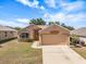 Charming single-story home with a two-car garage, well-manicured lawn, and neutral color palette at 533 Ronshelle Ave, Haines City, FL 33844