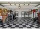 Organized two-car garage with checkerboard tile flooring and ample storage shelving at 533 Ronshelle Ave, Haines City, FL 33844