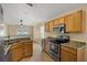 Functional kitchen with modern stainless steel appliances, light wood cabinets, and granite countertops at 533 Ronshelle Ave, Haines City, FL 33844