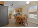 Eat-in kitchen area with stainless appliances, adjacent to a dining table and a bright window at 533 Ronshelle Ave, Haines City, FL 33844