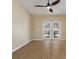 Neutral living area featuring brown tile flooring and a ceiling fan, leading to a patio through glass doors at 533 Ronshelle Ave, Haines City, FL 33844