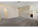 Expansive living area with an open layout, neutral carpet, and doorway to the bedroom at 533 Ronshelle Ave, Haines City, FL 33844