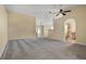 Open-concept living room with neutral carpet, ceiling fan, leading to the kitchen and dining area at 533 Ronshelle Ave, Haines City, FL 33844
