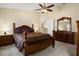 Comfortable main bedroom with a ceiling fan, featuring a full-sized bed and dresser at 533 Ronshelle Ave, Haines City, FL 33844