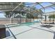 Screened in backyard with sparkling pool and spa, complete with patio furniture and hammock at 533 Ronshelle Ave, Haines City, FL 33844