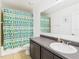 Bathroom with a tiled floor, a shower with a decorative curtain, and a vanity with a sink at 5787 Dornich Dr, Auburndale, FL 33823