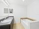 Bright bathroom features a double sink vanity and a relaxing soaking tub for comfort at 5787 Dornich Dr, Auburndale, FL 33823