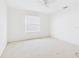 White bedroom with a window and neutral carpet at 5787 Dornich Dr, Auburndale, FL 33823
