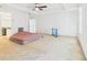 Spacious carpeted bedroom featuring entrances to a bathroom and closet with a tv at 5787 Dornich Dr, Auburndale, FL 33823