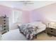 Bedroom with pink walls, carpeted floor, a window, and modern dresser at 5787 Dornich Dr, Auburndale, FL 33823