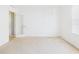 Bright bedroom features carpet, and a door with a floral design leading to an adjacent space at 5787 Dornich Dr, Auburndale, FL 33823