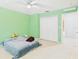 Green bedroom with carpet flooring, a ceiling fan, and a large double closet at 5787 Dornich Dr, Auburndale, FL 33823