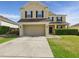 Two-story home with a wide driveway, attached two car garage, and manicured lawn at 5787 Dornich Dr, Auburndale, FL 33823
