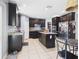 Large kitchen featuring dark wood cabinets, granite countertops, and stainless appliances at 5787 Dornich Dr, Auburndale, FL 33823