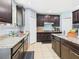 Well-equipped kitchen showcasing granite countertops and dark cabinets at 5787 Dornich Dr, Auburndale, FL 33823