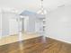 Open living room with tile and wood flooring, neutral walls and a decorative lighting fixture at 5787 Dornich Dr, Auburndale, FL 33823