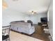 An expansive living room showcasing hardwood floors and a sectional sofa with ceiling fan at 5787 Dornich Dr, Auburndale, FL 33823