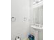 Clean white powder room featuring a pedestal sink, mirror, and stylish fixtures at 5787 Dornich Dr, Auburndale, FL 33823