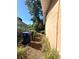 View of the side of the home, landscaping, and trash receptacles at 620 Se Oleander Se Dr, Winter Haven, FL 33880