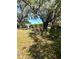 View of the backyard with trees and an outbuilding at 620 Se Oleander Se Dr, Winter Haven, FL 33880